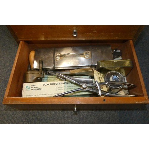 3095 - A vintage dentist's seven drawer mahogany cabinet containing dental instruments and equipment