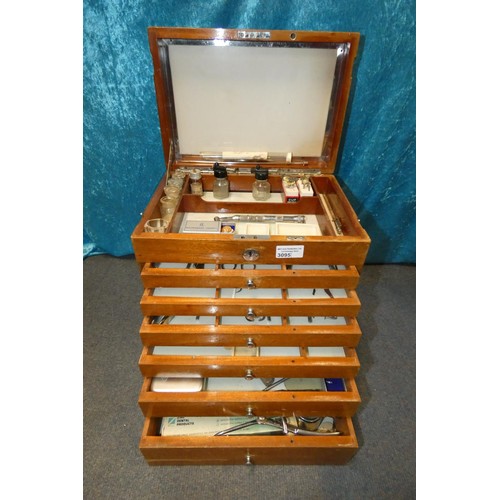 3095 - A vintage dentist's seven drawer mahogany cabinet containing dental instruments and equipment