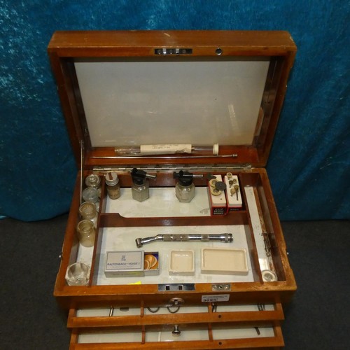 3095 - A vintage dentist's seven drawer mahogany cabinet containing dental instruments and equipment