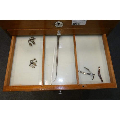 3095 - A vintage dentist's seven drawer mahogany cabinet containing dental instruments and equipment