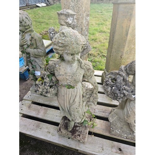 2923 - A weathered concrete statue of a lady carrying flowers