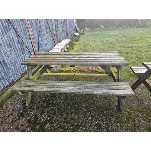 2932 - A wooden picnic table with fitted benches