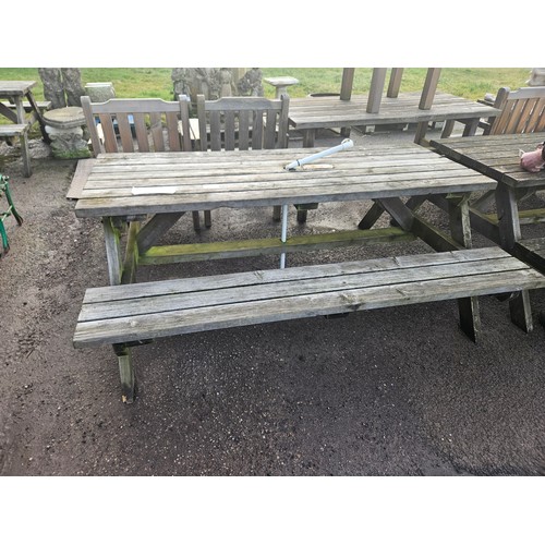 2934 - A wooden picnic table with fitted benches