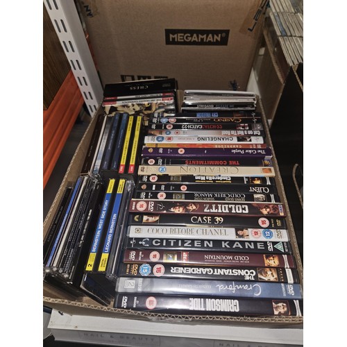 2638 - A large quantity of various DVDs and CDs, contents of 3 shelves