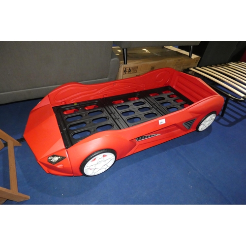 641 - A child's novelty red plastic bed frame the in style of a sports car. Please note that no mattress i... 