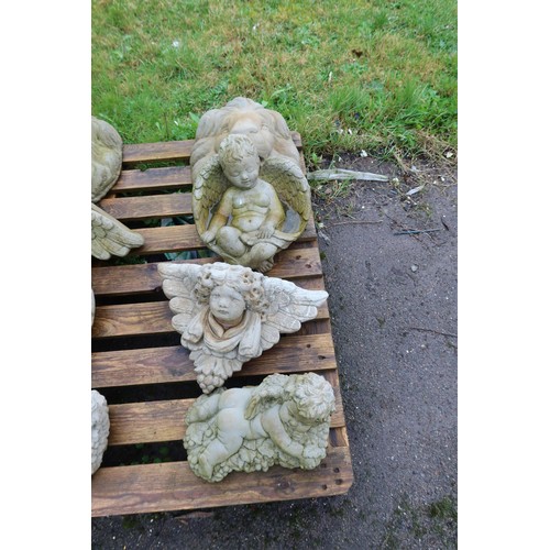 2531 - 1 concrete cherub lying on a bed of grapes, a concrete cherub bird bath, a wall plaque and lion head... 