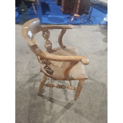 3377 - A vintage smokers bow chair with a wooden seat