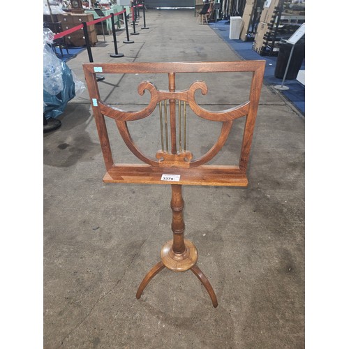 3379 - A vintage mahogany adjustable music stand with a tripod base