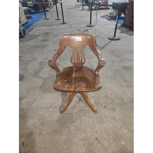 3382 - An Edwardian Oak swivel office elbow chair with a wooden seat