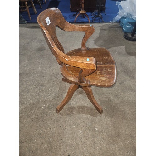 3382 - An Edwardian Oak swivel office elbow chair with a wooden seat