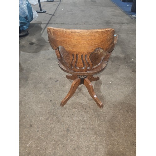 3382 - An Edwardian Oak swivel office elbow chair with a wooden seat