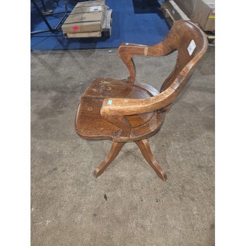 3382 - An Edwardian Oak swivel office elbow chair with a wooden seat