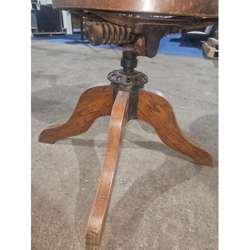 3382 - An Edwardian Oak swivel office elbow chair with a wooden seat