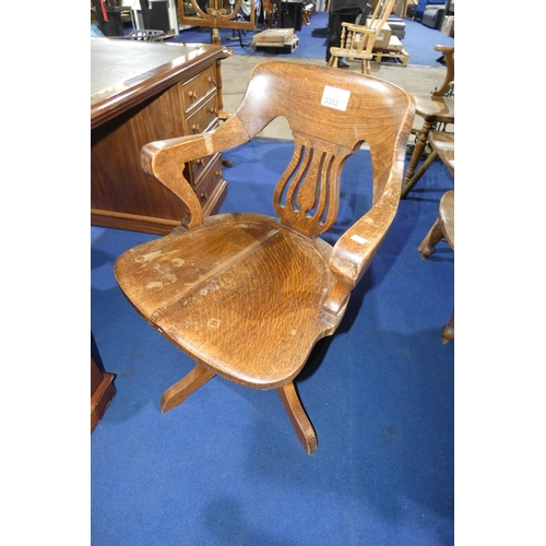 3382 - An Edwardian Oak swivel office elbow chair with a wooden seat