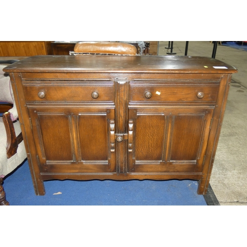 3390 - A vintage dark wood Ercol sideboard with two drawers and two doors, approximately 123 cm wide