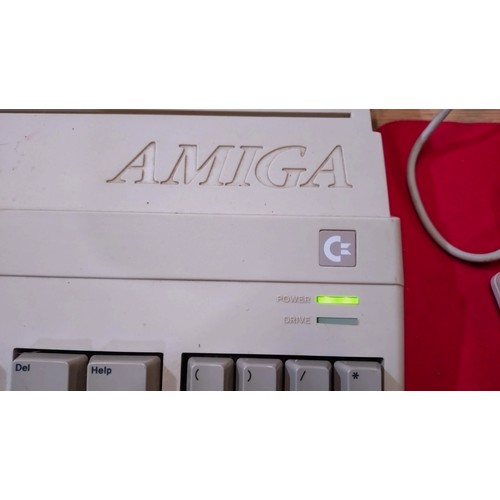 2384 - A vintage Commodore Amiga with monitor, joysticks and a large selection of games - trade. Lights up ... 