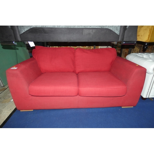 1173 - A red upholstered two person sofa (no make visible) approx 180cm wide. Please note this sofa is used... 