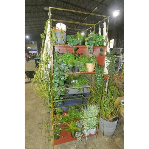 2241 - A shelving unit with a quantity of artificial plants, a couple of the plants are real