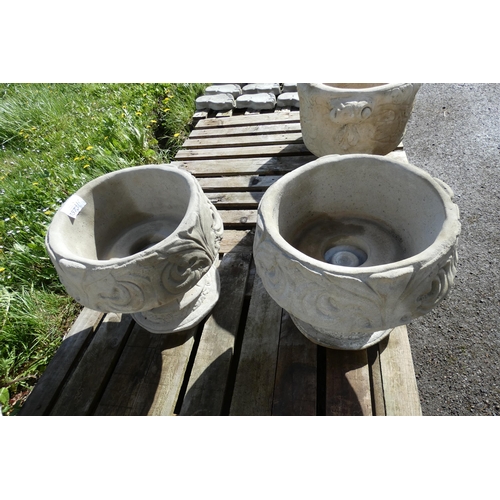 3573 - 2 round concrete planters with Fleur de lys design