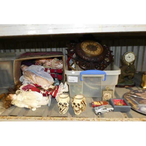 3202 - A quantity of various items including dolls, clocks etc, contents of 1 shelf