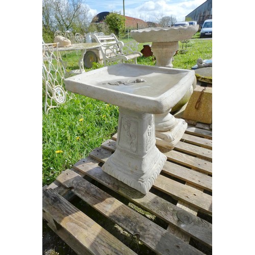 3586 - A square concrete bird bath adorned with a rose