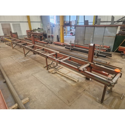 137 - A 12m long roller conveyor unit. Please note that this lot is welded to the three vertical supports ... 