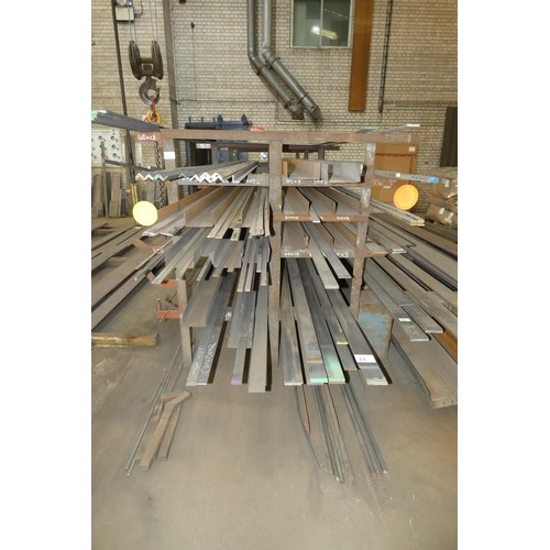31 - A storage rack containing a quantity of various stock steel including plate, bar, angle and channel.... 