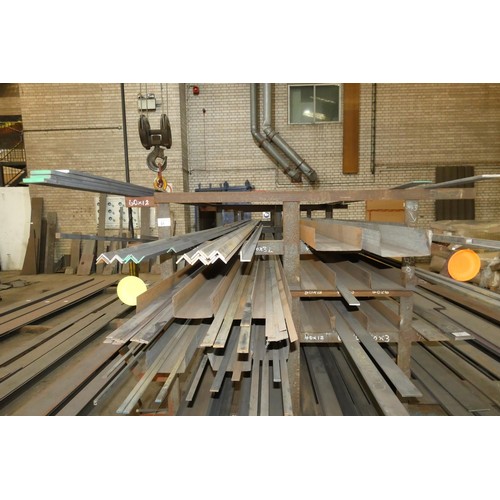 31 - A storage rack containing a quantity of various stock steel including plate, bar, angle and channel.... 