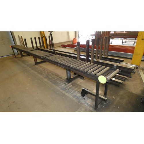 104 - A large vertical post stock steel storage rack welded to a 7m long roller conveyor unit. This lot is... 