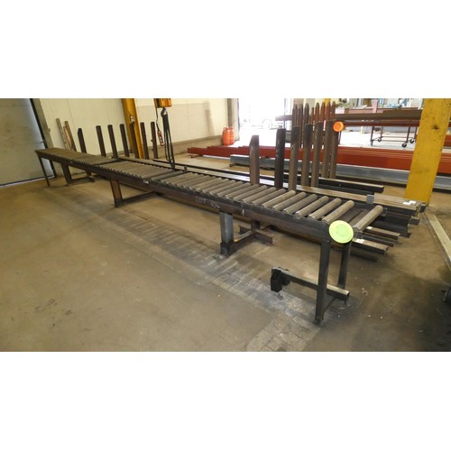 104 - A large vertical post stock steel storage rack welded to a 7m long roller conveyor unit. This lot is... 