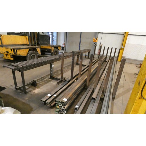 104 - A large vertical post stock steel storage rack welded to a 7m long roller conveyor unit. This lot is... 