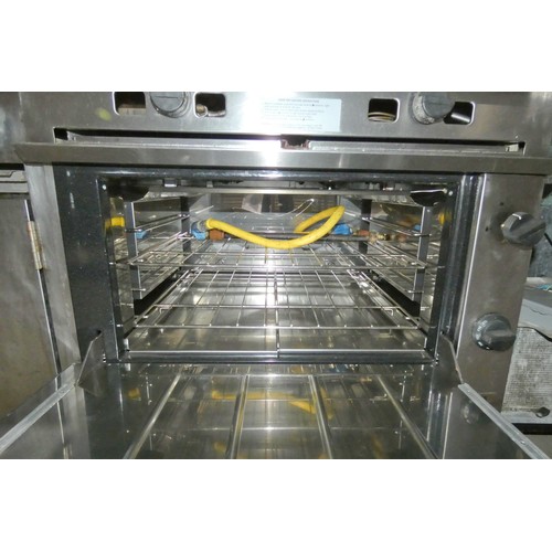 1020 - A commercial stainless steel solid top range with oven beneath, no make or model visible, gas - trad... 