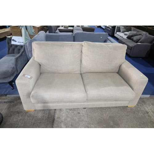 465 - A beige upholstered sofa approx 183cm wide. Please note that this sofa is used and is in good condit... 