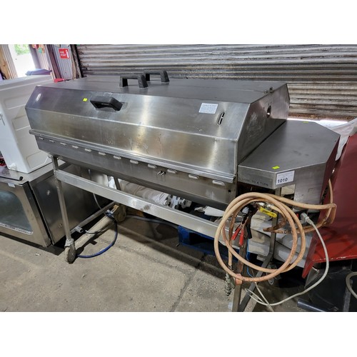 1010 - A tall commercial stainless steel mobile gas fired hog roast driven by a 12v  motor, approx 162x65x1... 