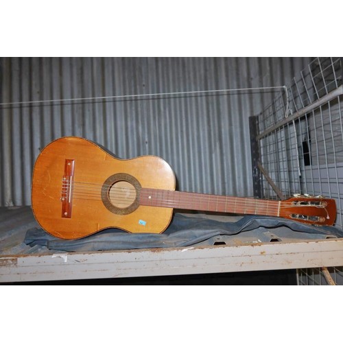 2410 - A small acoustic guitar with soft carry case, no make or model visible