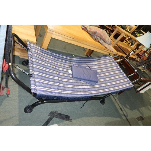 2175 - A blue stripped hammock with a black metal stand