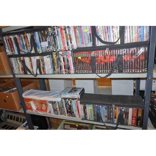 2438 - A large quantity of various DVDs, contents of 2 shelves