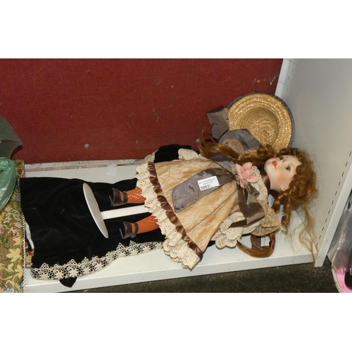 3003 - A decorative doll and a child's vintage velvet jacket and trousers