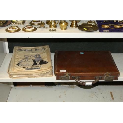 3032 - A vintage leather music case and sheet music