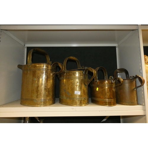 3038 - Four large graduated brass watering cans