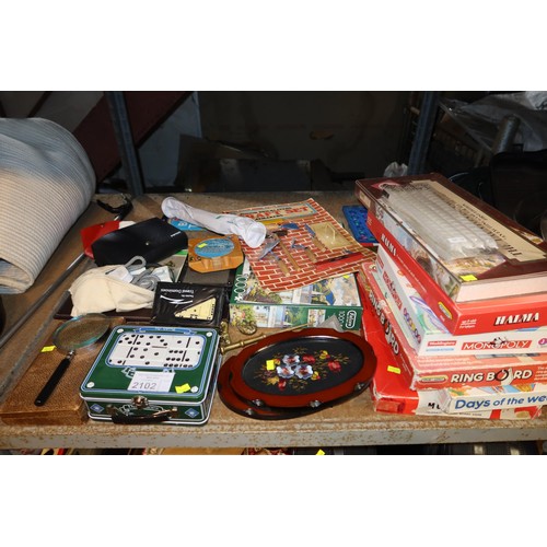 2102 - A quantity of various items including games, 2 x irons 240v, suitcases, Christmas decorations, ornam... 