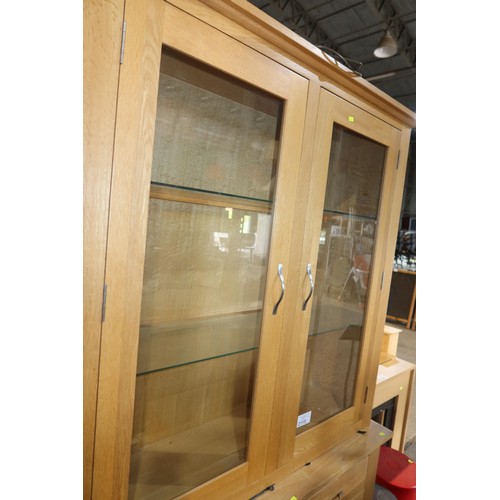 2115 - A light Oak two part sideboard / dresser with 2 glass doors above and 2 drawers / 2 doors below appr... 