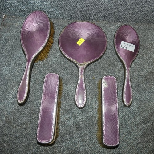 Two silver and enamelled backed hand mirrors and three matching brushes