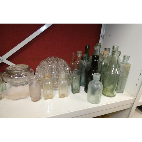 3029 - A quantity of various tall glass vases, a collection of vintage glass bottles, decorative glass orna... 