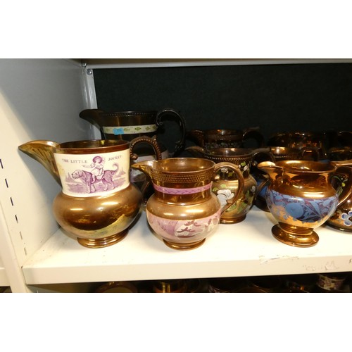 3034 - A large quantity of miscellaneous decorative bronze lustre jugs, tankards and goblets etc (two shelv... 