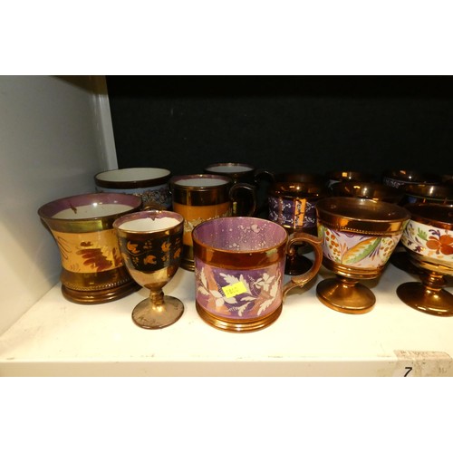 3034 - A large quantity of miscellaneous decorative bronze lustre jugs, tankards and goblets etc (two shelv... 