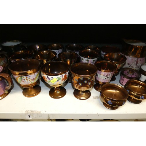 3034 - A large quantity of miscellaneous decorative bronze lustre jugs, tankards and goblets etc (two shelv... 