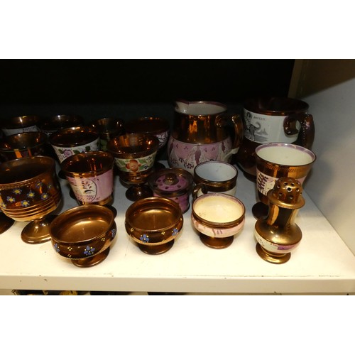 3034 - A large quantity of miscellaneous decorative bronze lustre jugs, tankards and goblets etc (two shelv... 