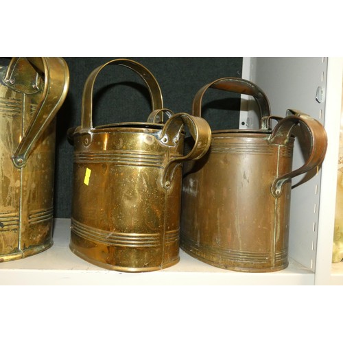 3038 - Four large graduated brass watering cans