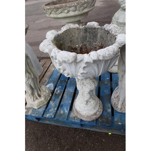 2708 - A decorative concrete planter on a pedestal